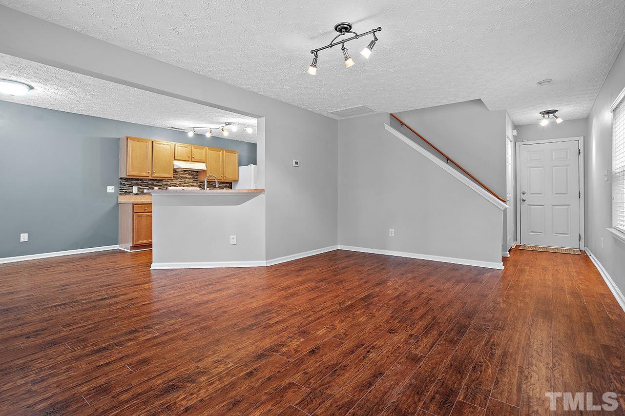 1909 Rathie Drive Durham, NC 27703 - Photo 6 of 32 a view of empty room with wooden floor and fan