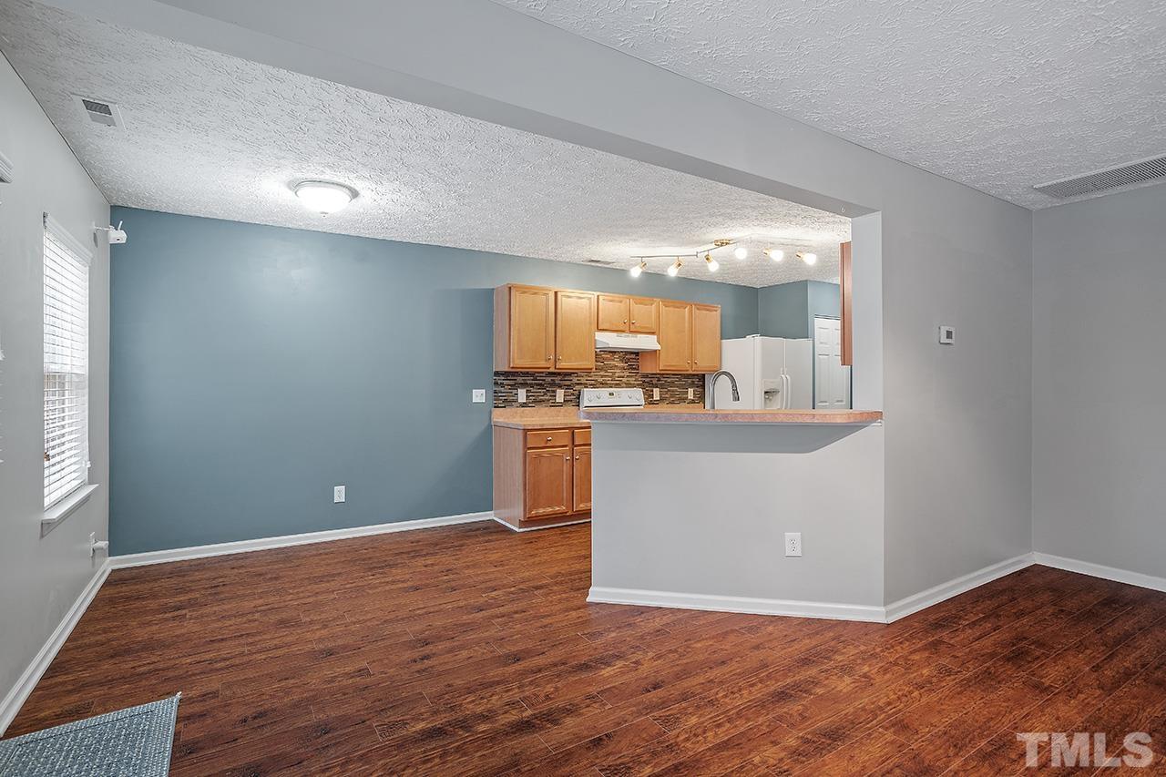 1909 Rathie Drive Durham, NC 27703 - Photo 8 of 32 a view with kitchen island wooden floor