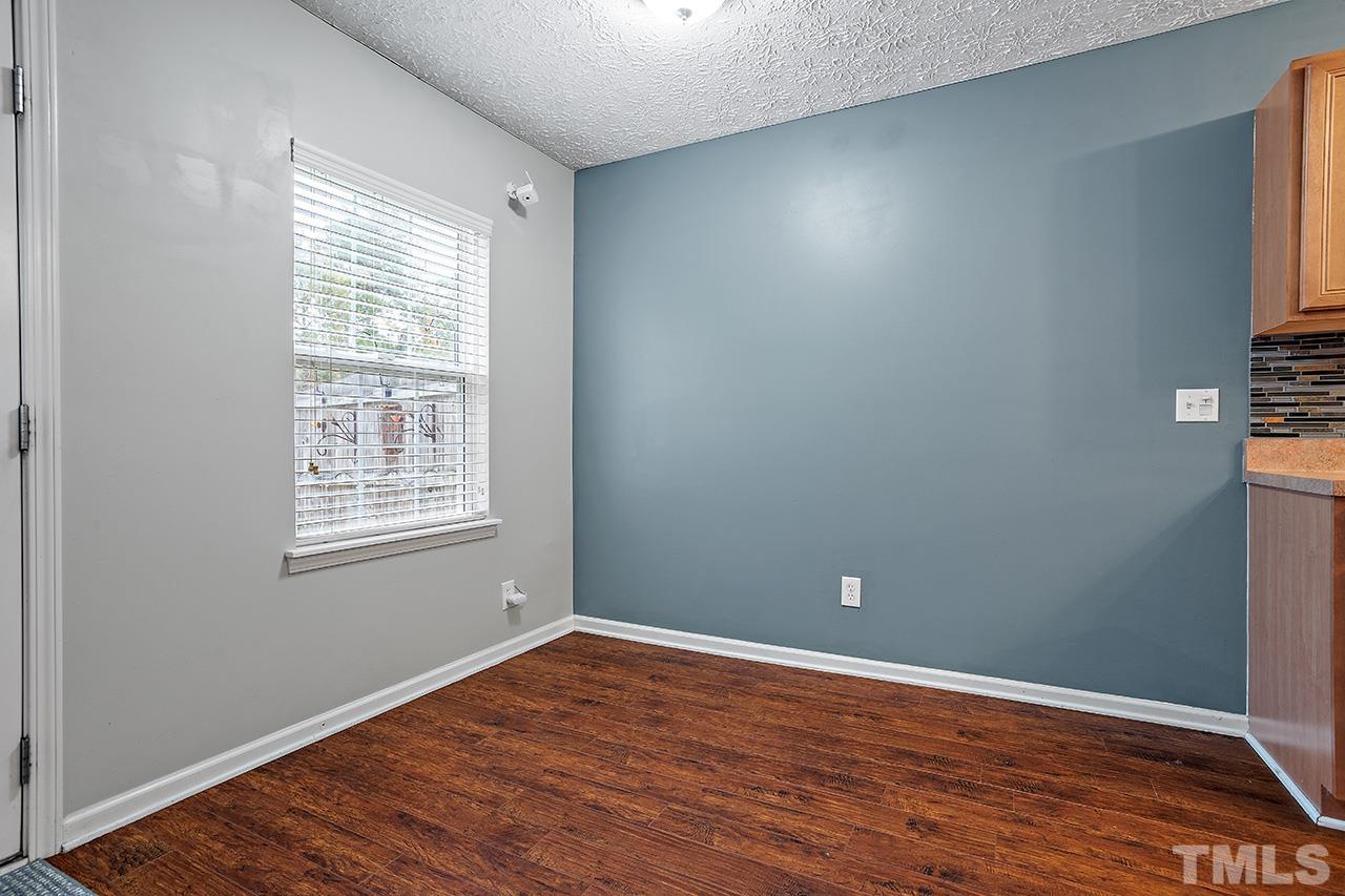 1909 Rathie Drive Durham, NC 27703 - Photo 9 of 32 wooden floor in an empty room with a window