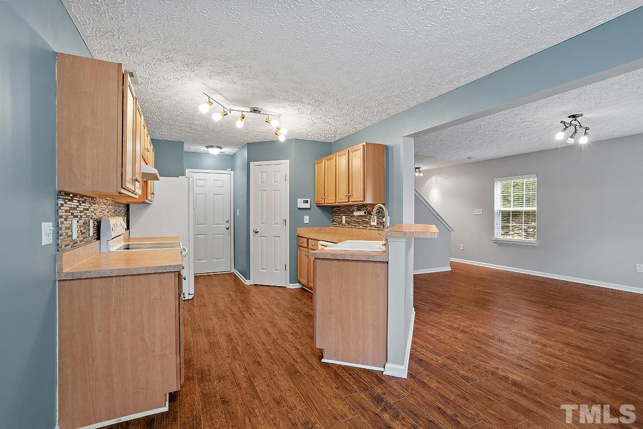 1909 Rathie Drive Durham, NC 27703 - Photo 10 of 32 a kitchen with cabinets and wooden floor