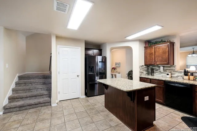 a kitchen with a stove a sink and a refrigerator