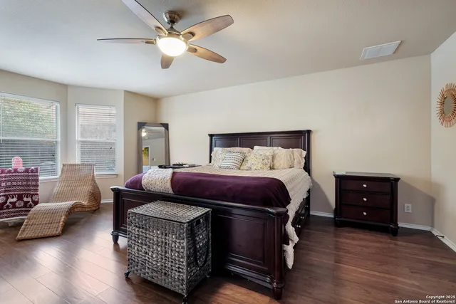 a bedroom with furniture and a large window