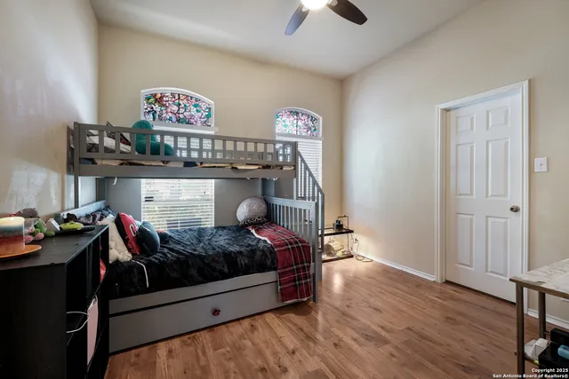 a room with a bed and wooden floor