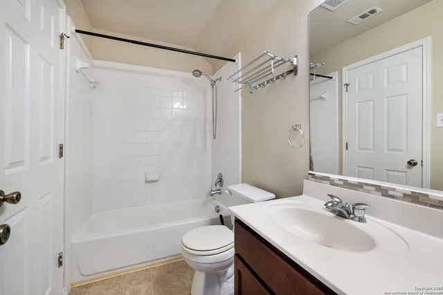 a bathroom with a sink toilet tub and shower