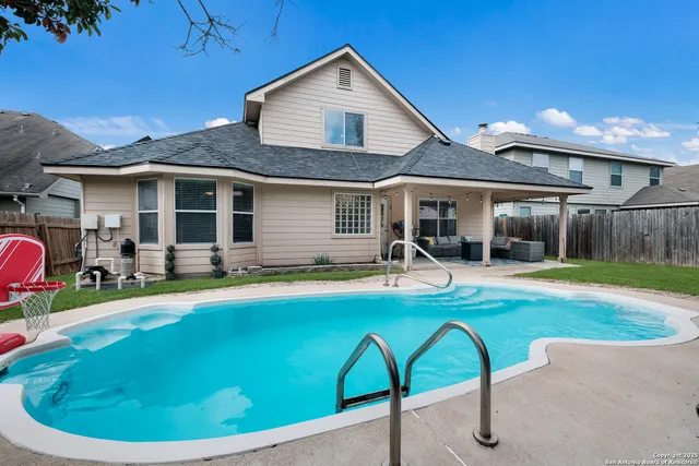 a view of a house with swimming pool and a chairs