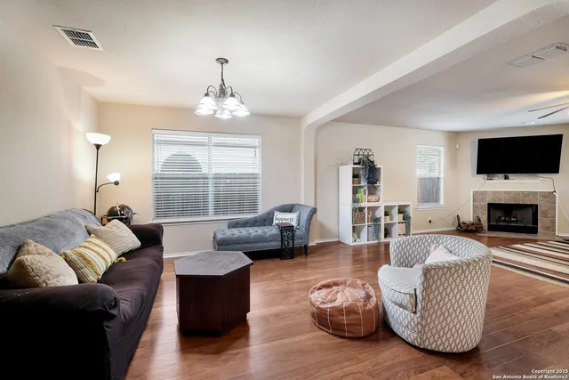 a living room with furniture fireplace and flat screen tv