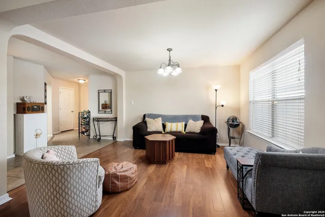 a living room with furniture and a wooden floor