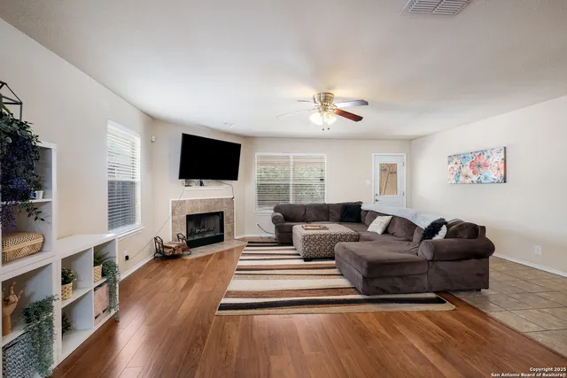 a living room with furniture a fireplace and a flat screen tv