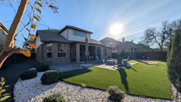 a view of a house with a yard patio and a fire pit