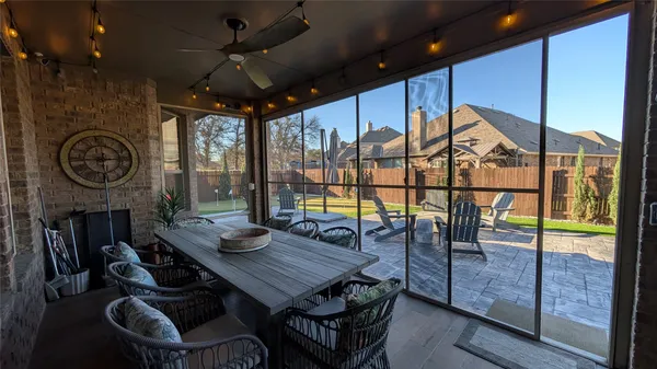 a dining room with furniture and a floor to ceiling window