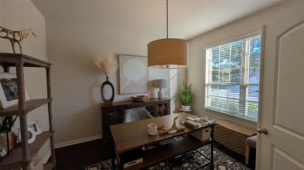 a living room with furniture a window and a flat screen tv