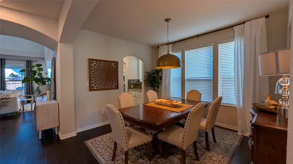 a kitchen with sink a refrigerator and chairs