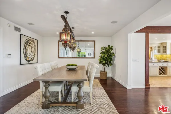 a view of a dining room with furniture wooden floor and chandelier