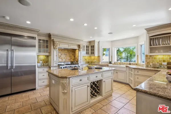 a kitchen with stainless steel appliances granite countertop a sink and a stove