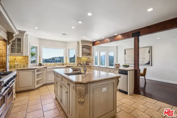 a kitchen with stainless steel appliances granite countertop a sink and cabinets