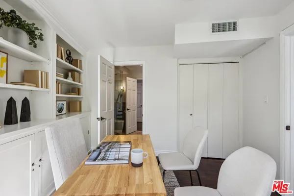 a bedroom with a large bed and a potted plant