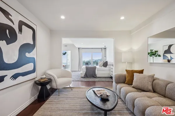a lobby with a couch and potted plants