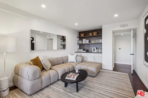 a view of a kitchen with refrigerator and wooden floor