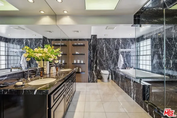 a bedroom with two beds and wooden floor