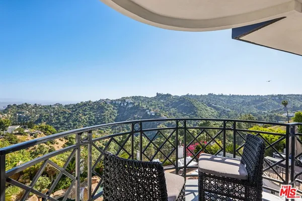 a view of a house with swimming pool and furniture
