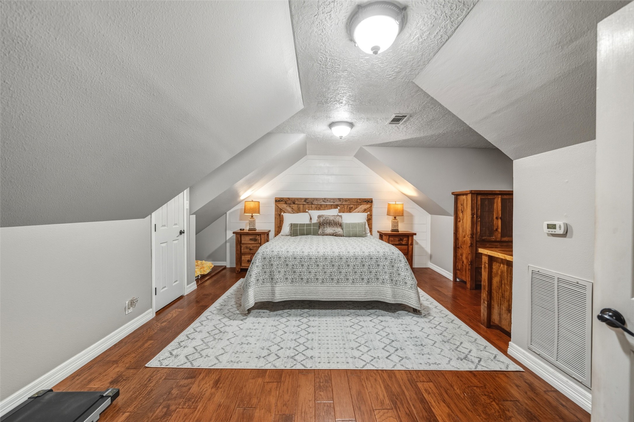 19989 Meadow Bend Road Hempstead, TX 77445 - Photo 18 of 35 Spacious upstairs primary bedroom provides privacy, wood flooring, and a calm retreat separate from the main living areas.