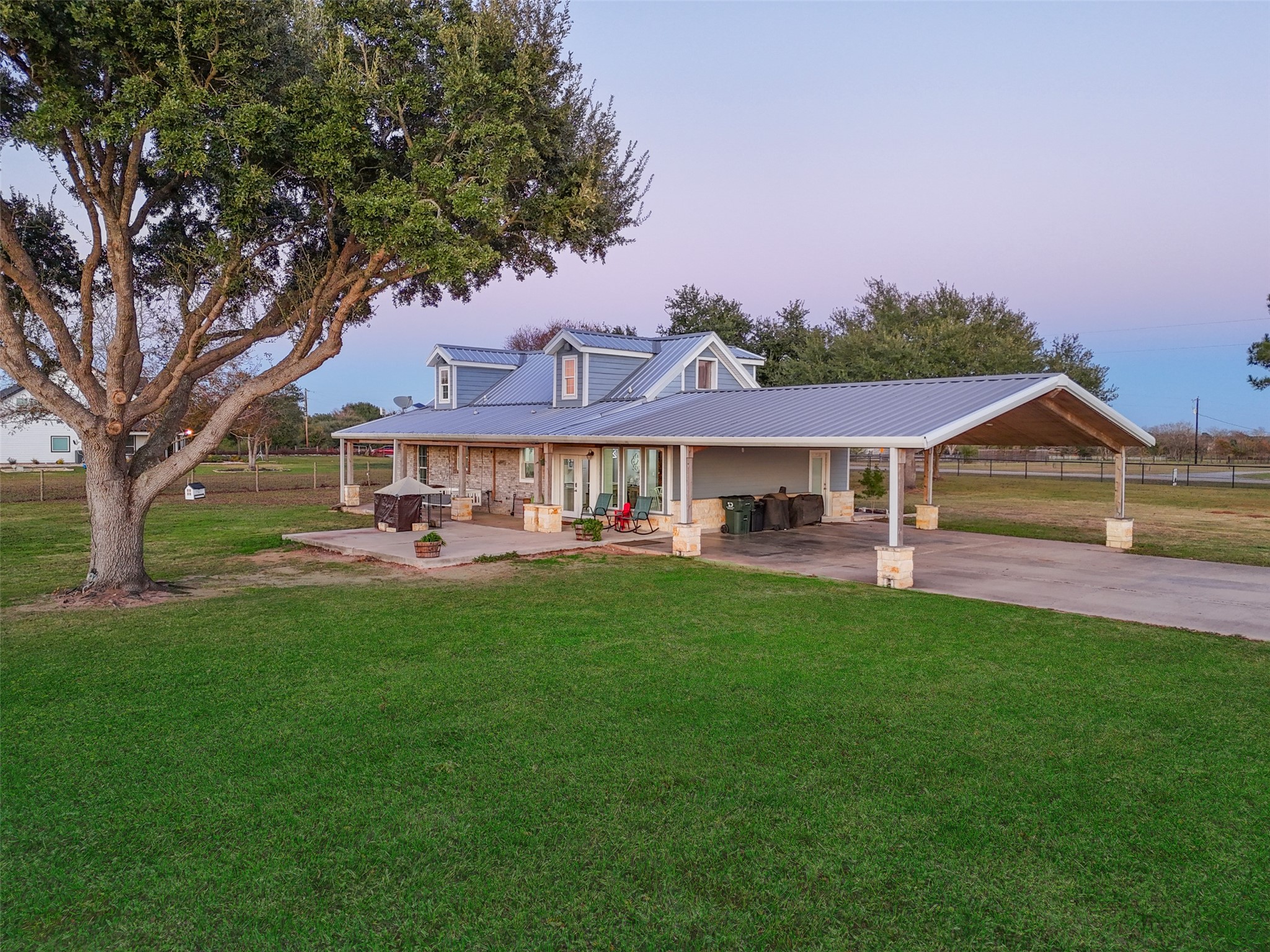 19989 Meadow Bend Road Hempstead, TX 77445 - Photo 33 of 35 Side view highlights the covered carport and extended porch, providing shaded parking and outdoor seating options.