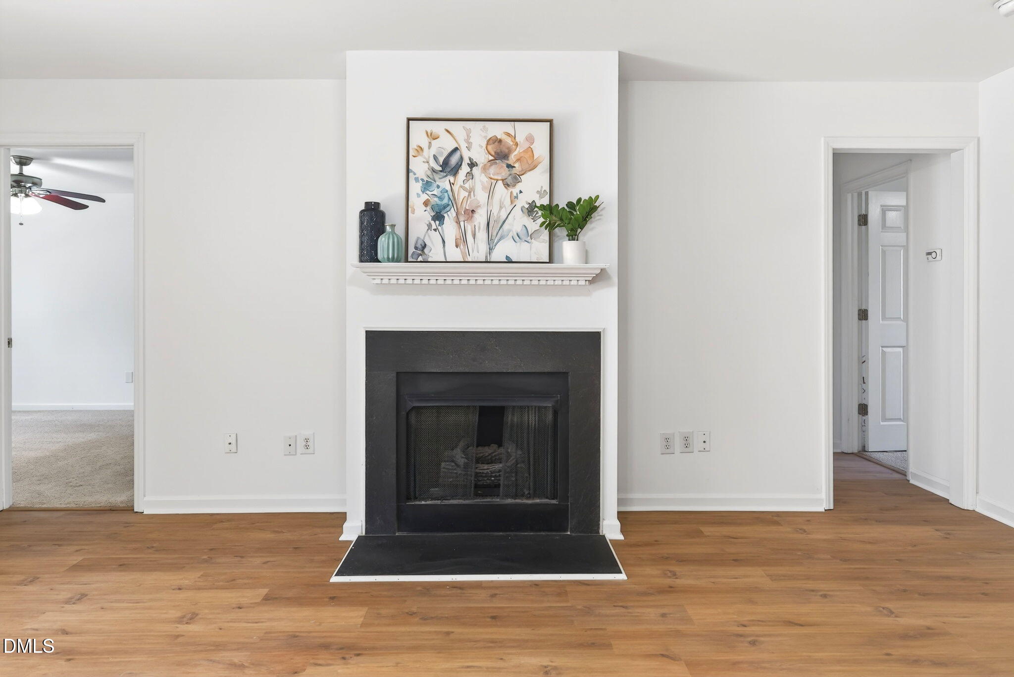 3612 Wellington Ridge Loop Cary, NC 27518 - Photo 14 of 35 a view of an empty room with wooden floor and a fireplace