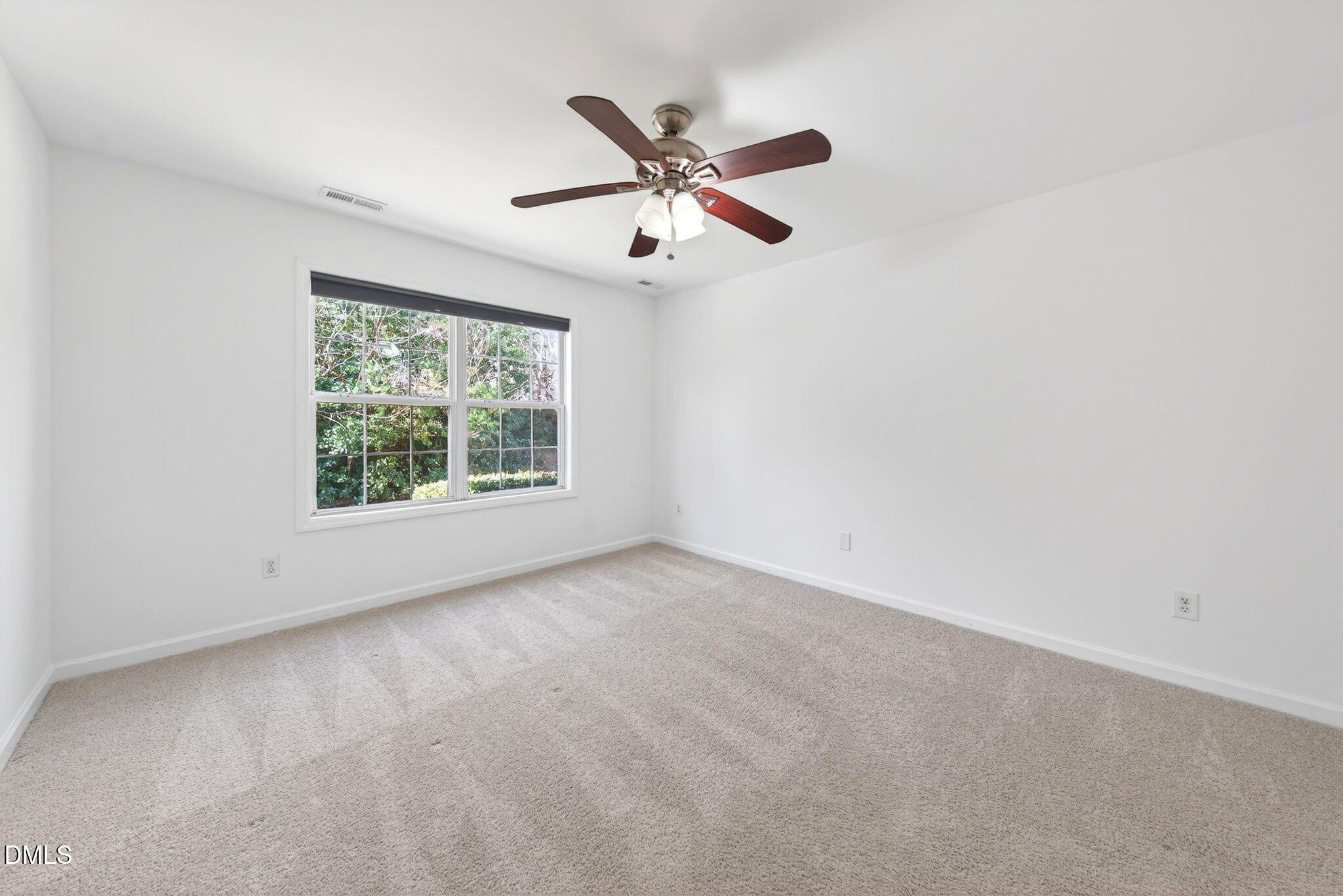 3612 Wellington Ridge Loop Cary, NC 27518 - Photo 19 of 35 an empty room with a window and a ceiling fan