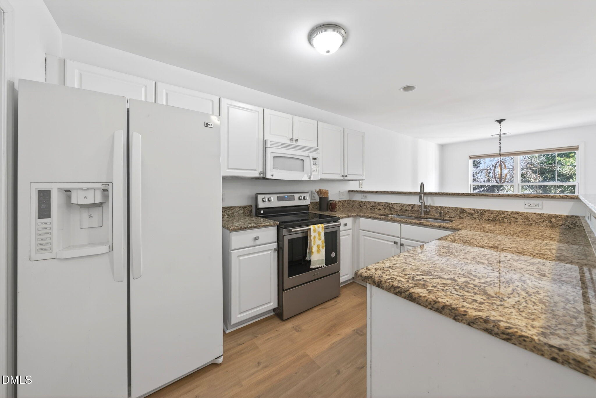 3612 Wellington Ridge Loop Cary, NC 27518 - Photo 4 of 35 a kitchen with granite countertop white cabinets and white appliances