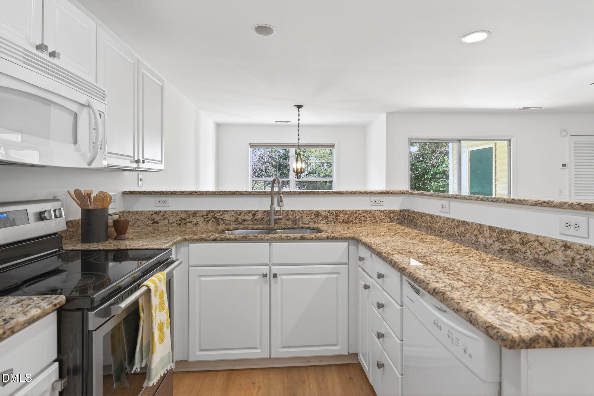 3612 Wellington Ridge Loop Cary, NC 27518 - Photo 6 of 35 a kitchen that has a sink a stove and cabinets