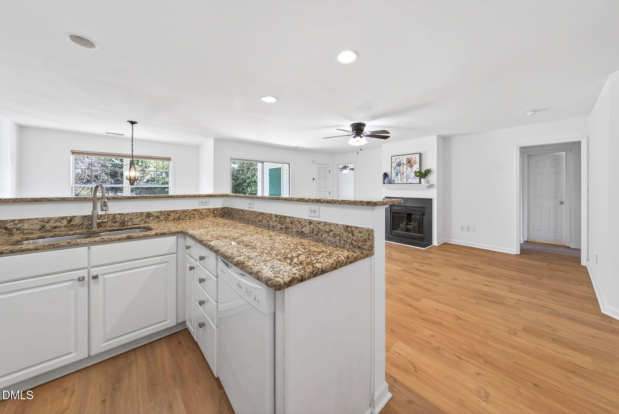 3612 Wellington Ridge Loop Cary, NC 27518 - Photo 7 of 35 a hall with kitchen island a sink dishwasher stove and wooden cabinets