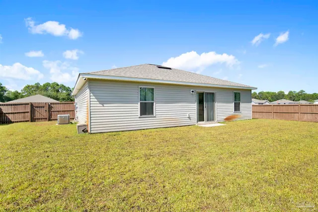 a view of a house with a backyard