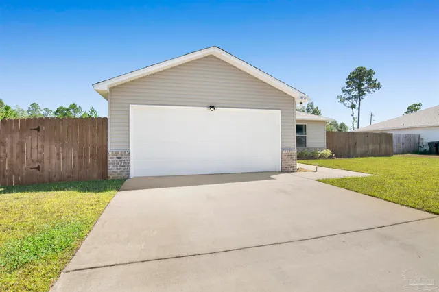 a front view of house with yard and outdoor seating
