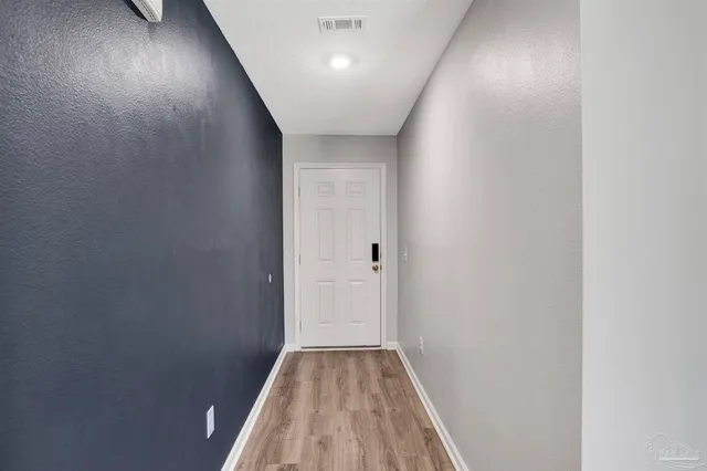 a view of hallway with wooden floor