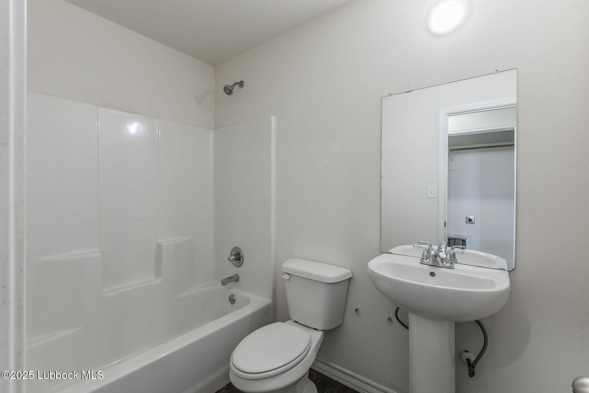 3511 East Colgate Street Lubbock, TX 79403 - Photo 12 of 18 a bathroom with a sink toilet and shower