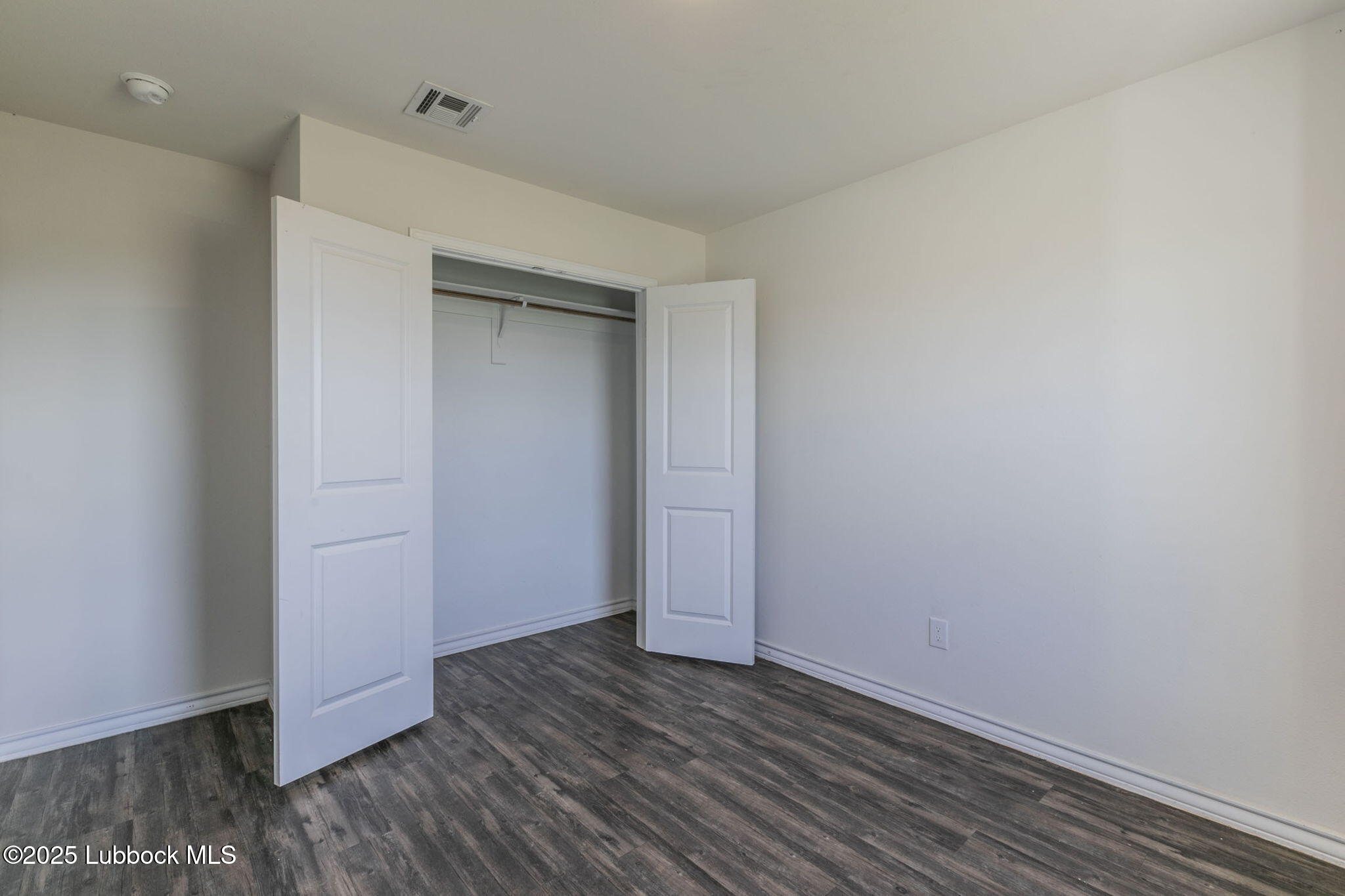 3511 East Colgate Street Lubbock, TX 79403 - Photo 14 of 18 a view of an empty room with wooden floor