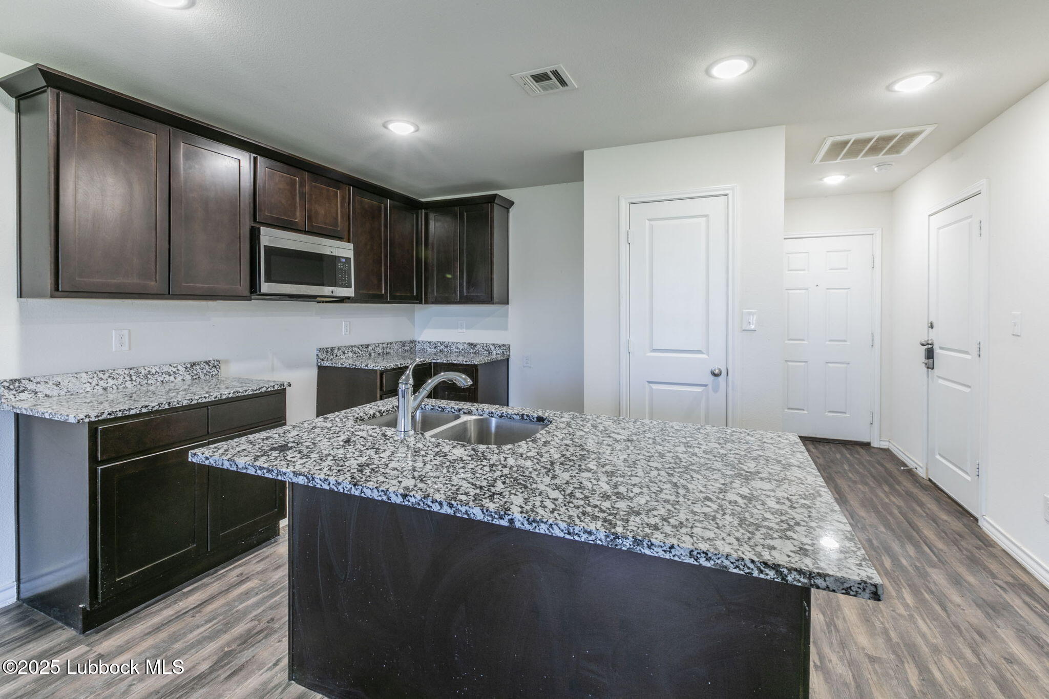 3511 East Colgate Street Lubbock, TX 79403 - Photo 5 of 18 a kitchen with kitchen island granite countertop counter top space appliances and cabinets