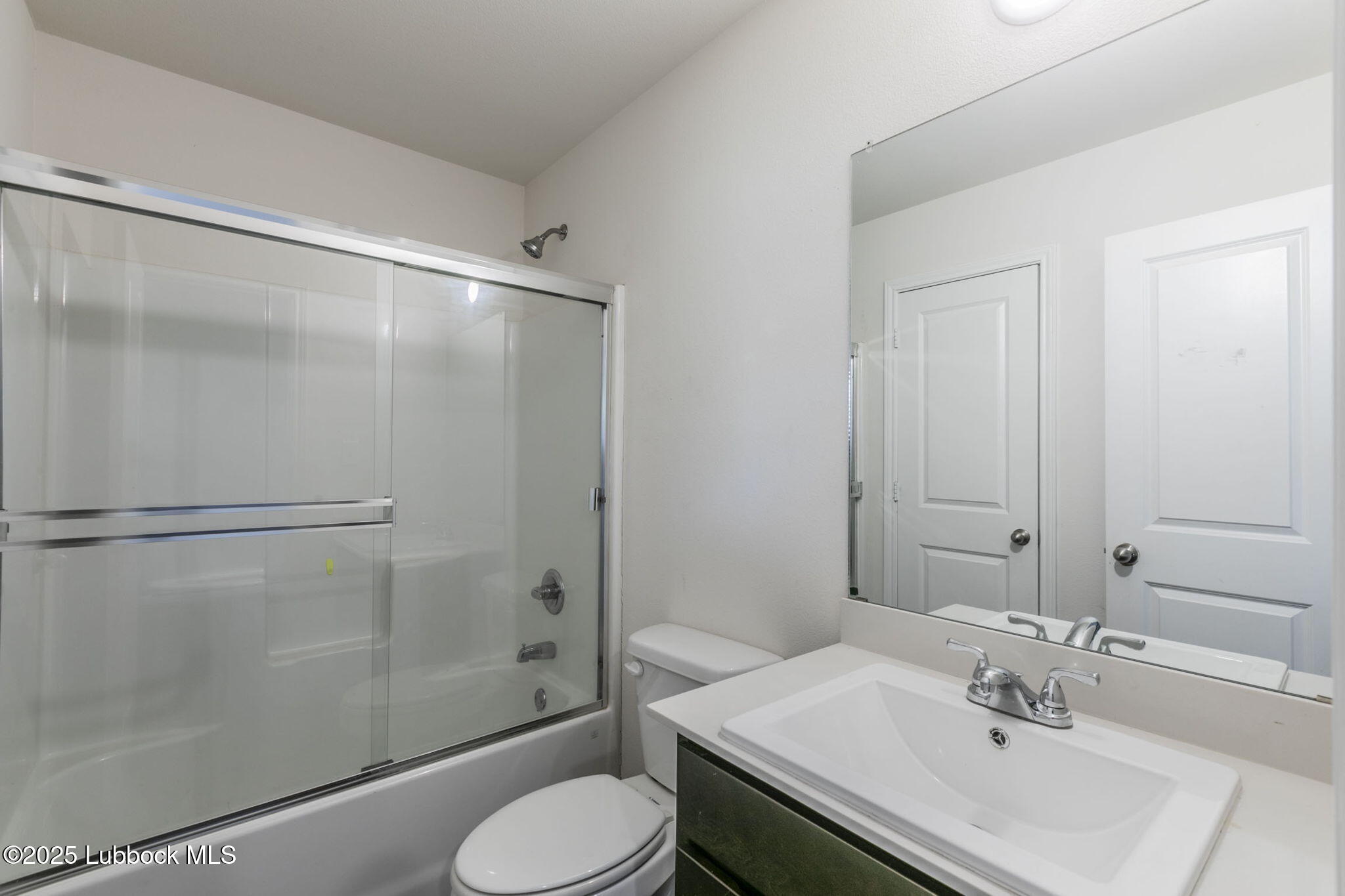 3511 East Colgate Street Lubbock, TX 79403 - Photo 9 of 18 a bathroom with a sink toilet and shower