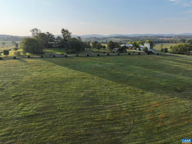 a view of a field with an ocean