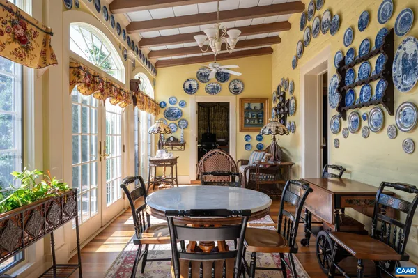a view of a dining room with furniture wooden floor and chandelier