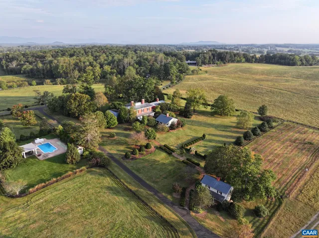 a view of a lake with a yard and outdoor seating
