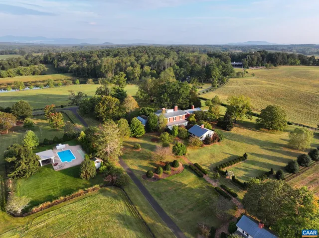 an aerial view of a house with garden space and street view