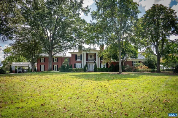 a front view of a house with a yard outdoor seating and garage