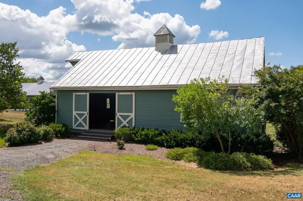 a aerial view of a house next to a yard