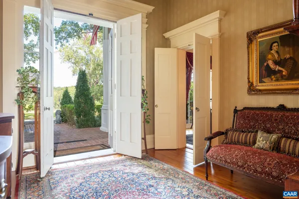 a view of a hallway with wooden floor and staircase