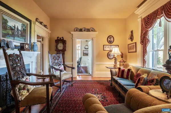 a view of a dining room with furniture wooden floor and a chandelier