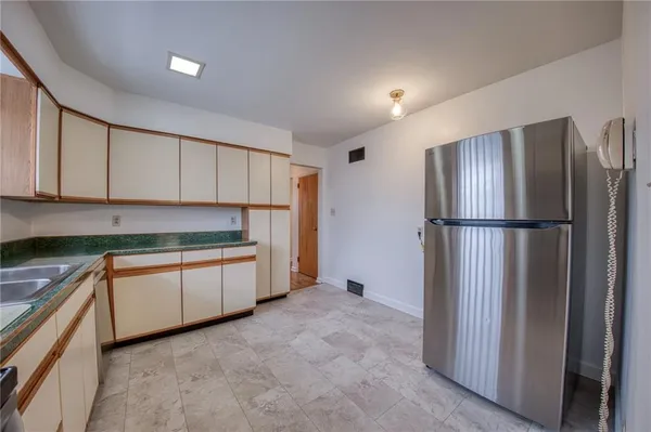 a kitchen with stainless steel appliances granite countertop a refrigerator and a sink
