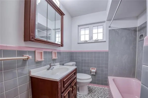 a bathroom with a sink toilet and mirror