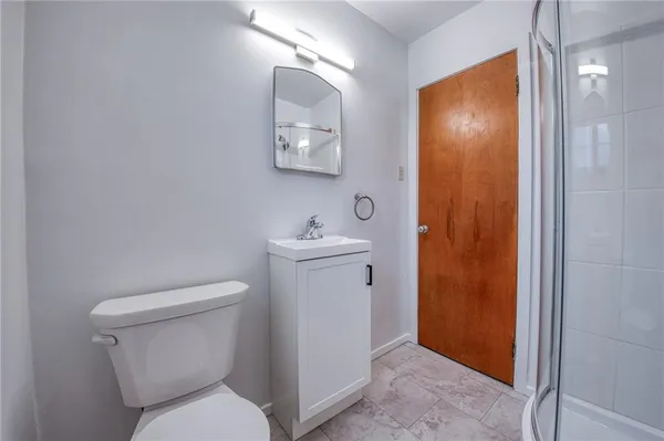 a white toilet sitting next to a bathroom sink