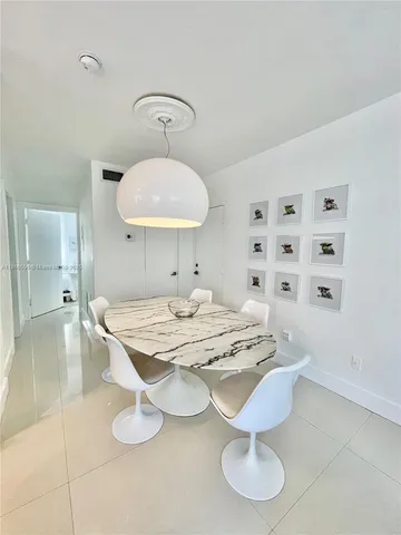 a dining room with granite countertop furniture and a chandelier